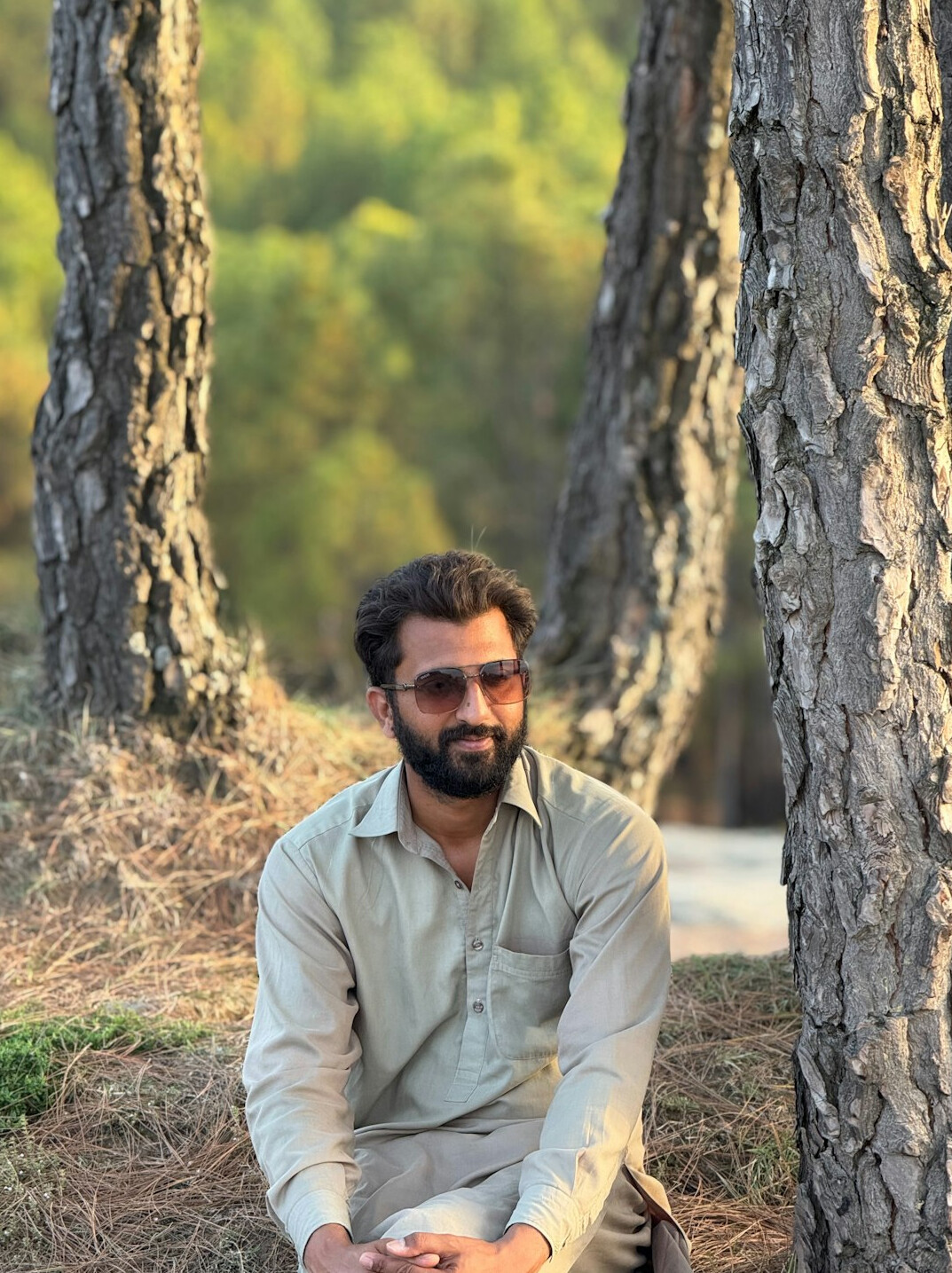 Portrait of a South Asian man in his thirties with glasses and a beard
